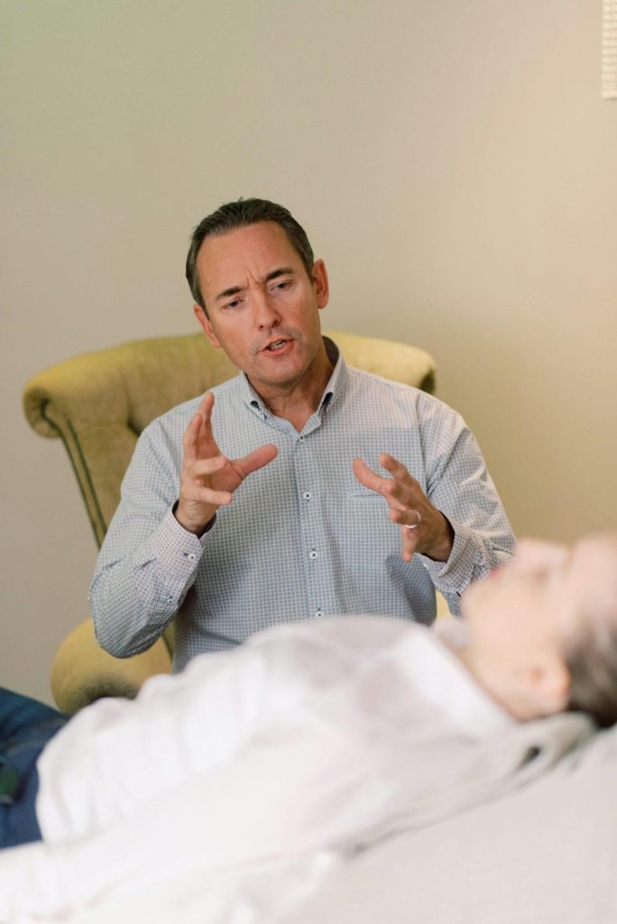 Therapist talking to a patient in session.