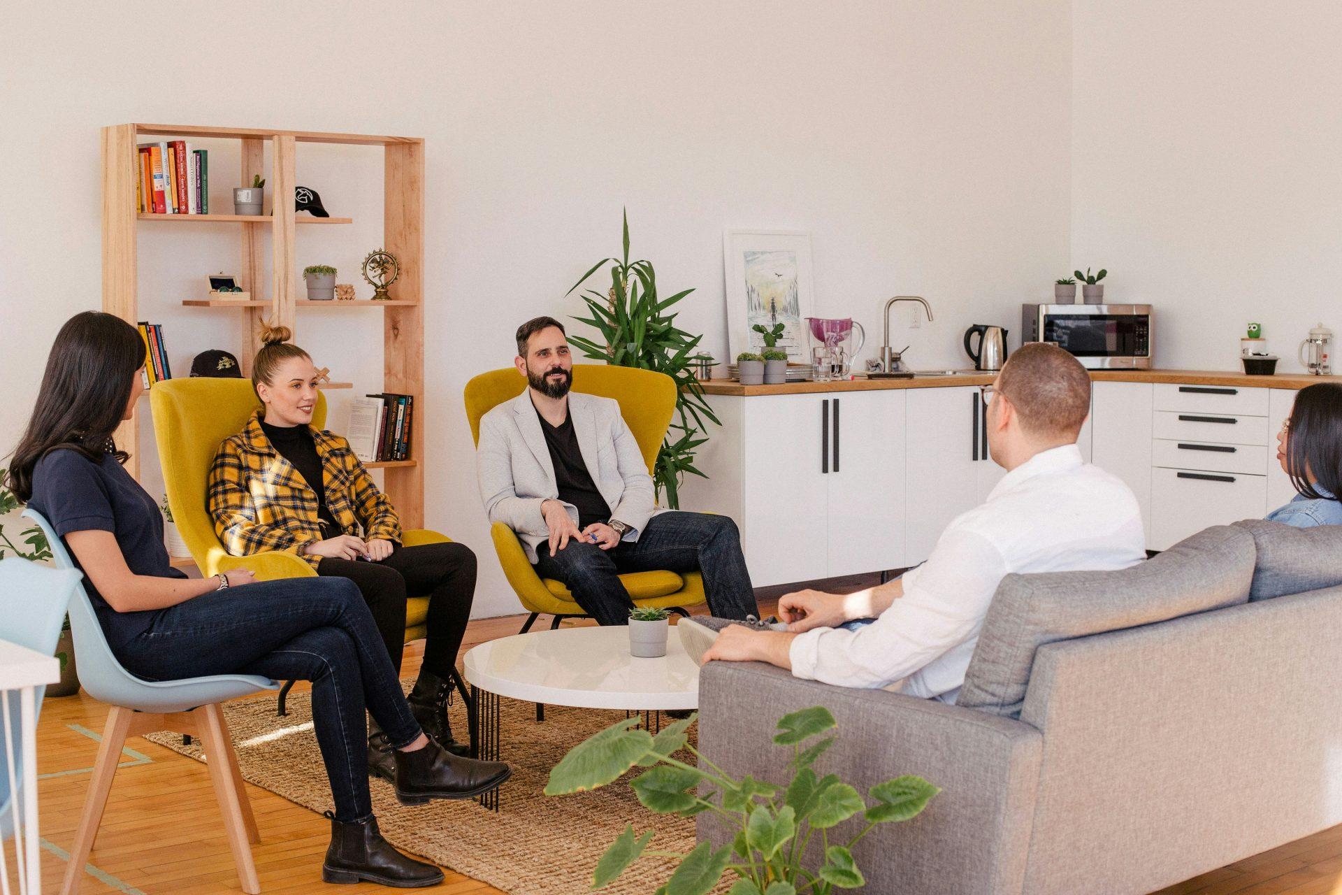 Group having a relaxed meeting in lounge.