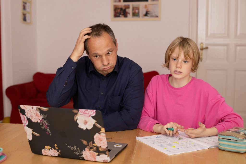 Confused father helping daughter with homework.
