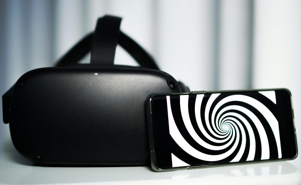 VR headset and phone displaying spiral image.